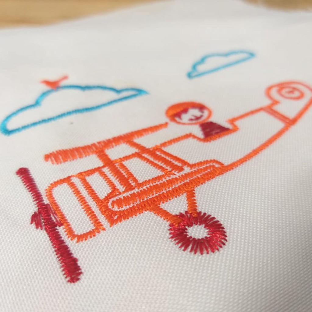 Niño en avión - Diseño de bordado a máquina